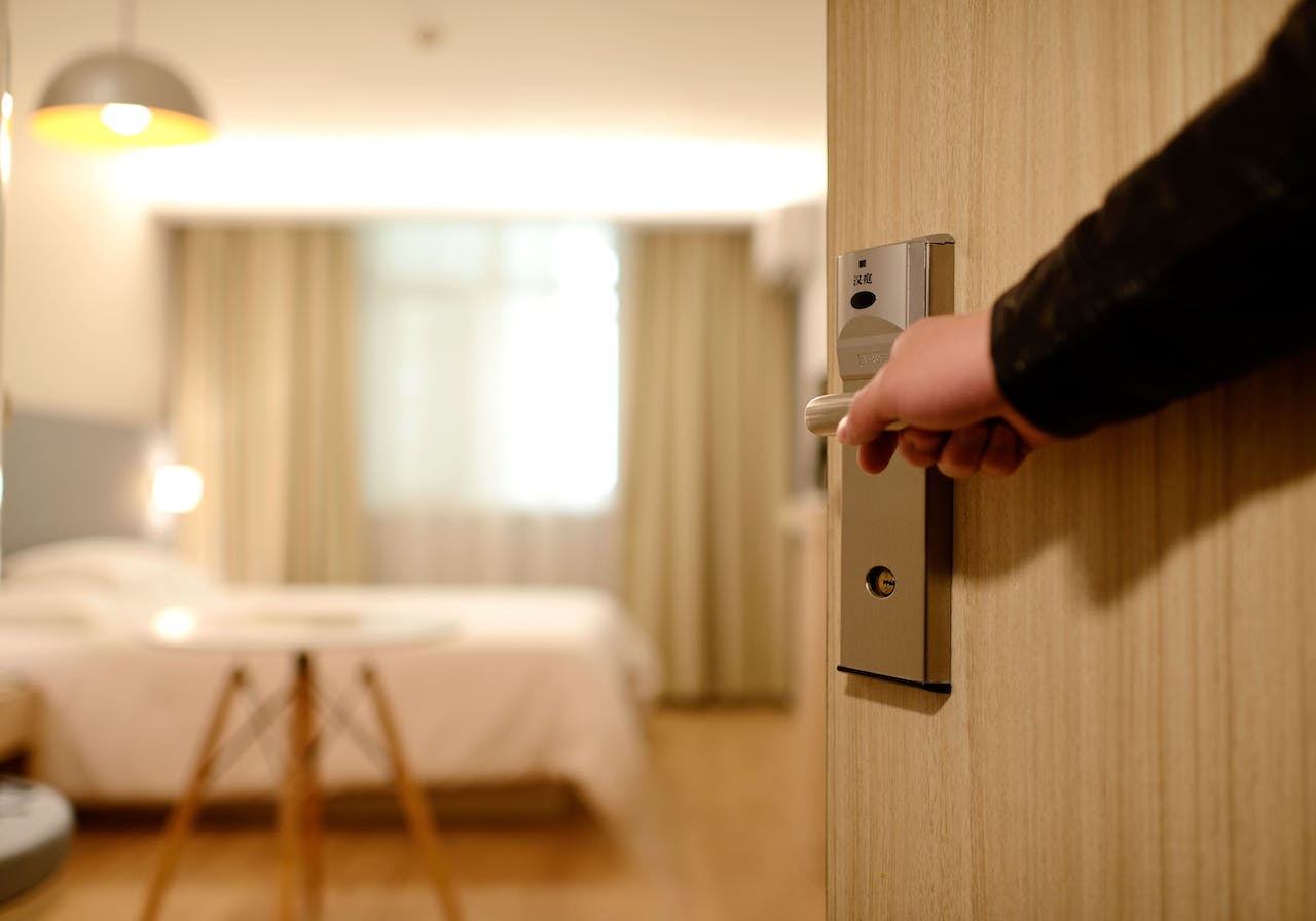 A door opening to reveal a hotel room
